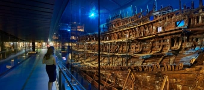Woman looking at the hull of the Mary Rose