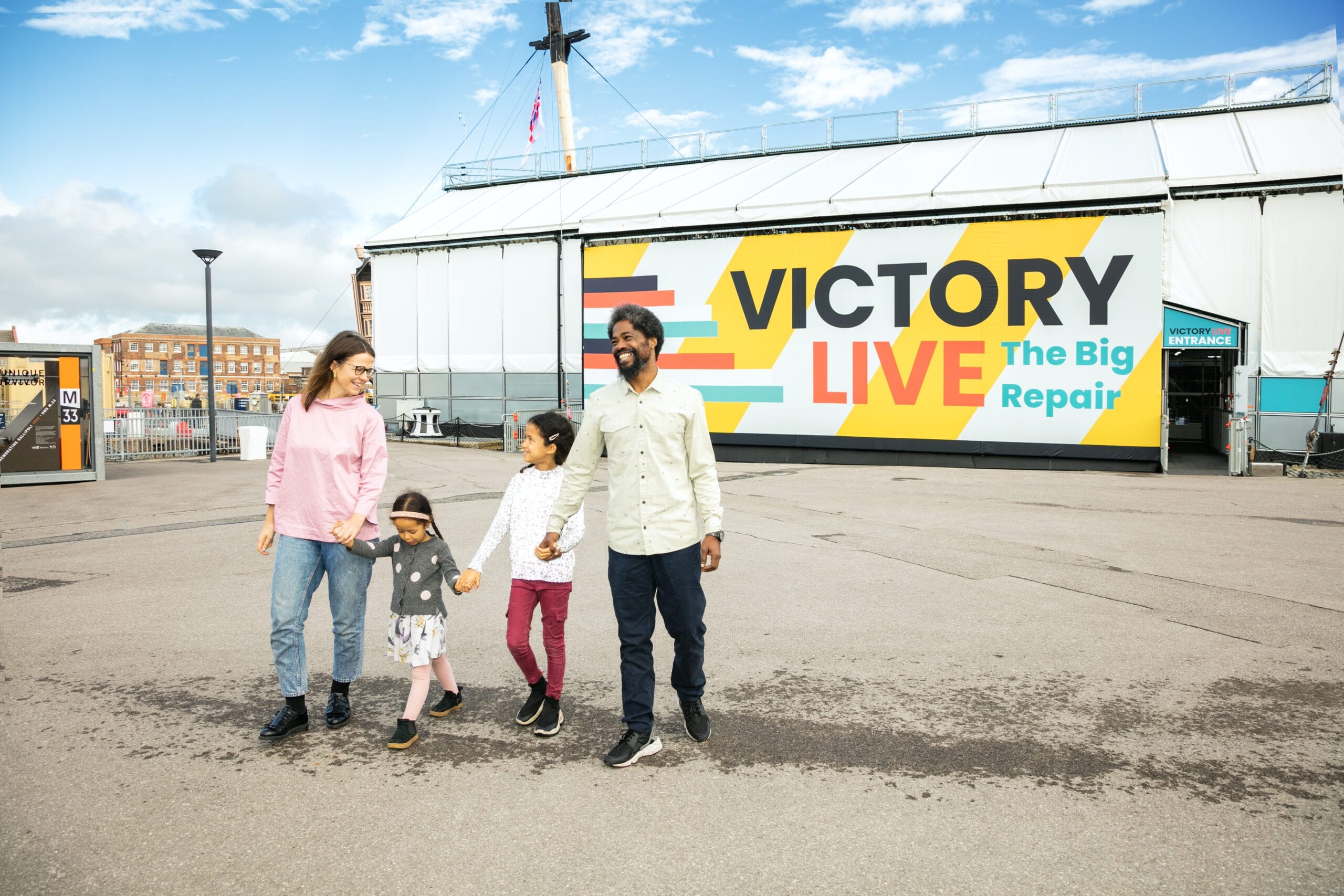 A family walking away from HMS Victory after enjoying the Victory Live exhibition